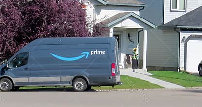 An Amazon Prime truck on the route in a neighbourhood during summer.