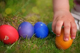Hand taking Easter egg