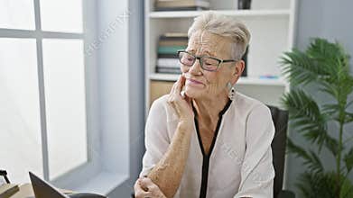 Senior grey-haired woman business worker in office, aching toothache pains strike during workday