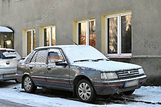 Old veteran or youngtimer classic European French classic sedan car Peugeot 309 parked