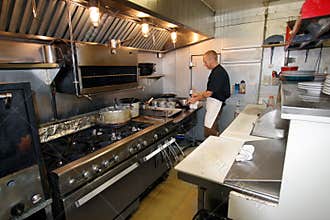 Chef at work in small kitchen