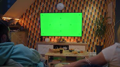 Couple watching movie on TV at home