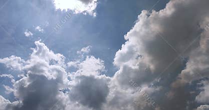Blue sky with clouds and black smoke from a campfire