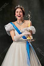 Happy birthday. Elegant woman, royal person, queen or princess in white medieval outfit tasting cake on dark vintage