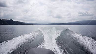 back of boat with engine running and splashing water, new zealand