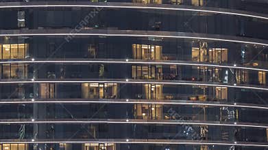 Outside view of windows in apartments of a high class building at night timelapse