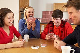 Family Playing Cards In Kitchen