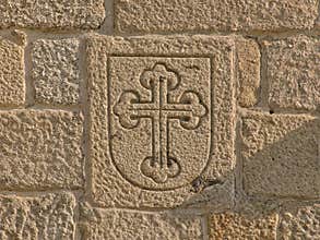 Shield with budded cross carved in stone