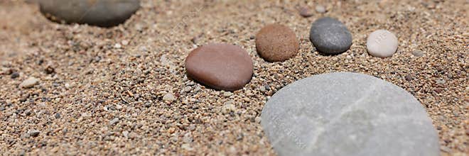 Footprint of stones in the sand, close-up, blurry
