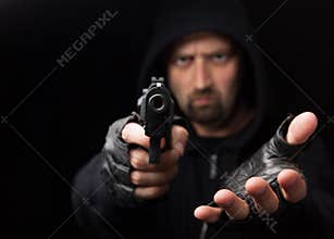 Robber with gun holding out hand