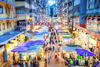Rush hour shoppers in motion along busy Fa Yuen Street night market in Hong Kong