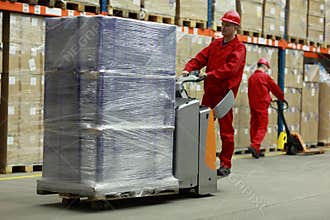 Two workers working in storehouse