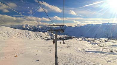 Hyperlapse tourist passenger pov chair lift operate with skiers down slope in fast motion in Gudauri, caucasus mountains. Blank