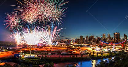 Spectacular fireworks display over Calgary downtown sunset city skyline during annual Calgary Stampede event