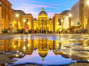 Dusk view of Saint Peter Basilica illuminated, Rome, Italy