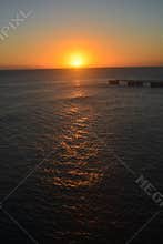 Vibrant Ocean Sunset with Fiery Orange Sky and Clouds