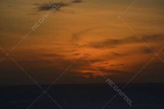 Dramatic Ocean Sunset with Fiery Orange Sky