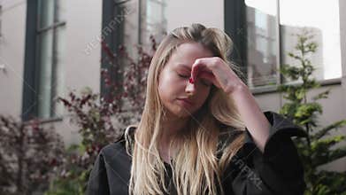 Portrait of sad young caucasian woman suffering from depression anxiety loneliness or mental health problem outdoors