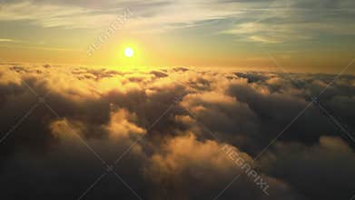Cinematic take off through the clouds at sunset. Above the sky. Clouds are like fluffy sheep. Romantic sunset.