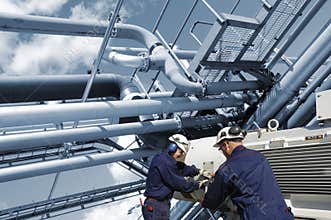 Oil and gas workers with fuel pipelines