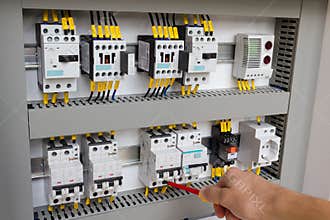 Technician working at electrical cabinet