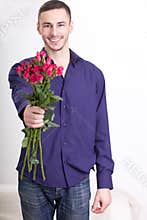 Young man giving flowers