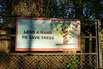 Eye-catching billboard urging environmental action: \'Lend A Hand To Save Trees,\'