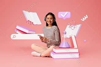Asian woman with smartphone and headphones studying on pink background