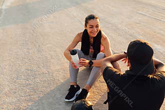 Smiling sportswoman looking at her fitness buddy