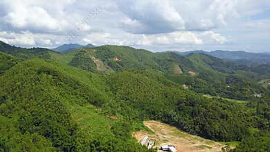 Outdoor green mountain forest scenery with blue sky and white clouds in Guangxi, China