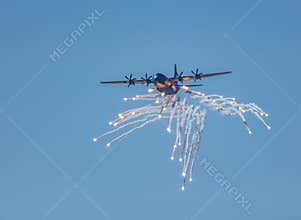 A RAAF Hercules transport aircraft deploying anti missile flares