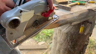 Worker sawing with a circular saw