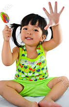 Cute asian baby girl and big lollipop