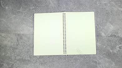 woman hand put agenda book or notebook and pen on marble grunge background