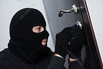 Burglar thief at house breaking