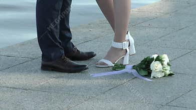 The legs of the bride and groom.