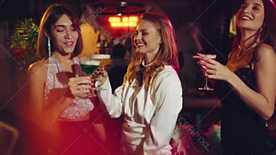 Happy, beautiful young girls, meeting in bar, drinking cocktails, dancing, celebrating birthday and holiday. Christmas