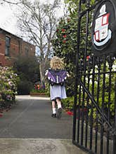 Small Girl Running Out Of The School Gate