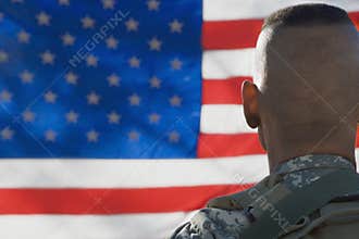 US Army Soldier Looking At Flag
