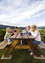Children having camp meal.