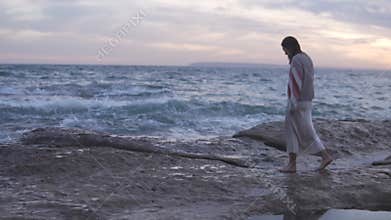 Happy free woman walking by the sea in the evening