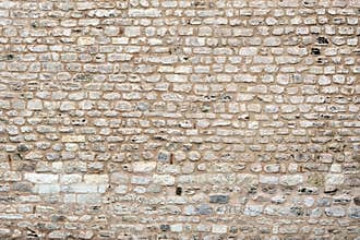 Old decorative wall made of beige stones medieval castle