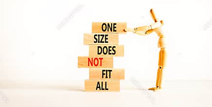 One size does not fit all symbol. Concept words One size does not fit all on wooden blocks. Businessman hand. Beautiful white