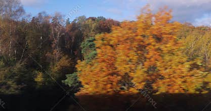 Train journey window view autumn colors