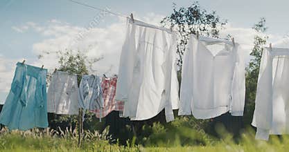 Wet clothes drying in the backyard of the house