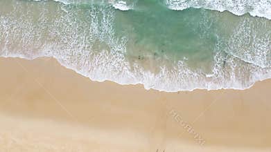 Aerial view of beautiful, calm sandy beach with waves. Seascape.