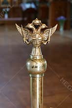 Double-headed eagle with two swords, cross and crown in the church