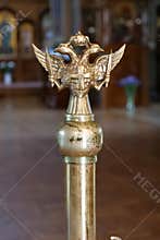 Double-headed eagle with two swords, a cross and a crown in the church