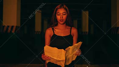 Woman Chanting from Old Paper in Candle Circle (Zoom In). Horror Ritual.