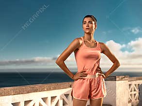 Fitness girl rest after practicing yoga or running outdoors. Fitness concept. Download a photo to advertise a fitness